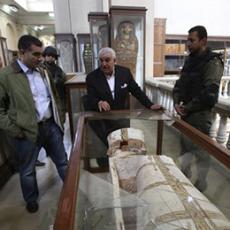 Zahi Hawass, center, standing near a damaged coffin at the Egyptian Museum in Cairo. He has announced plans to resign as head of the Ministry of State for Antiquities.