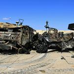 Destroyed military vehicles are seen at a naval military facility after last night's coalition air strikes in People's Port in eastern Tripoli, March 22, 2011