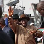 Nigeria President Goodluck Jonathan, centre, wave to his supporters during the final campaign rally, at Eagle Square in Abuja, Nigeria.  Nigeria's ruling party could face a possible runoff in the coming presidential election, March 26, 2011