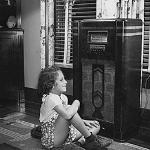 A young girl listening to the radio
