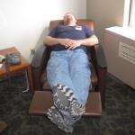 John Davis sleeping in a chair that reclines into bed while his wife is in the ICU.