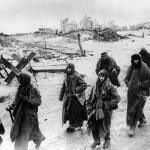 Captured German soldiers making their way in the cold through the ruins of Stalingrad